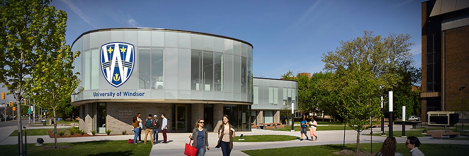 Exterior view of Welcome Centre with students and staff walking in front of the building