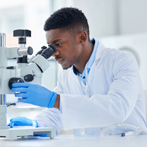 Innovation at UWindsor - Man looking through a microscope