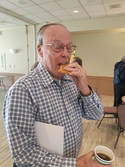 John McIntyre - eating a cookie, drinking a coffee.