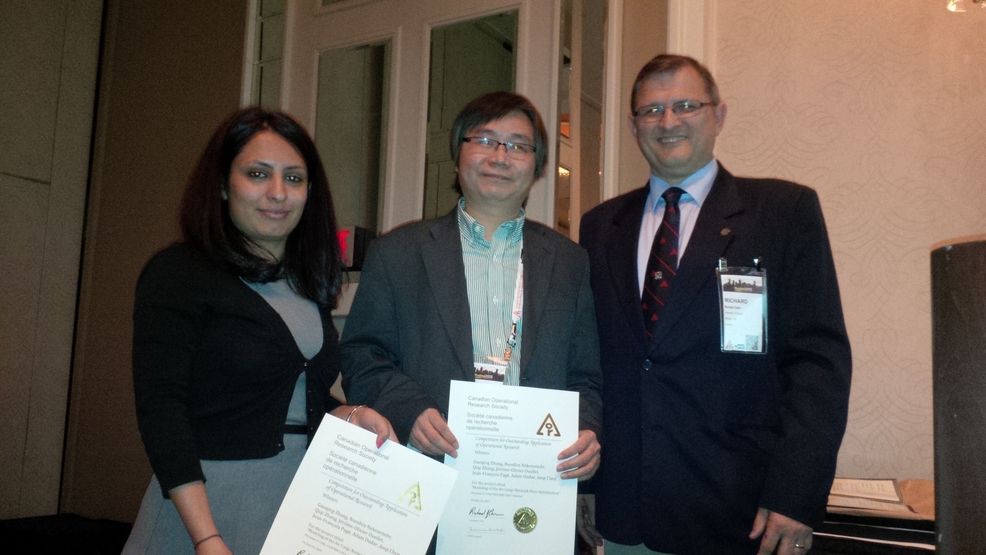 PhD student Nooshin Nekoiemehr and engineering professor Guoqing Zhang receiving their prize from the Canadian Operational Research Society.