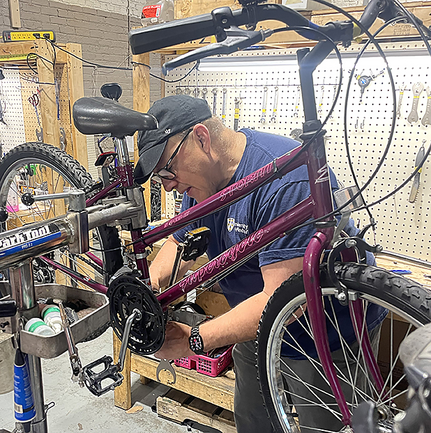 Robert Aguirre repairing bike