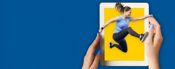 Woman jumping out of tablet computer