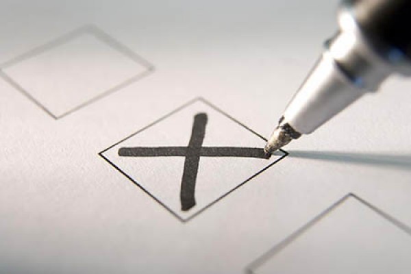 pen marking X on ballot