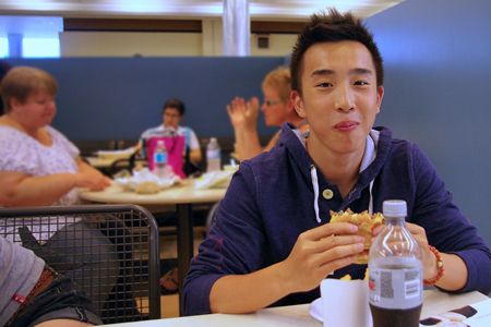 student eating a hamburger