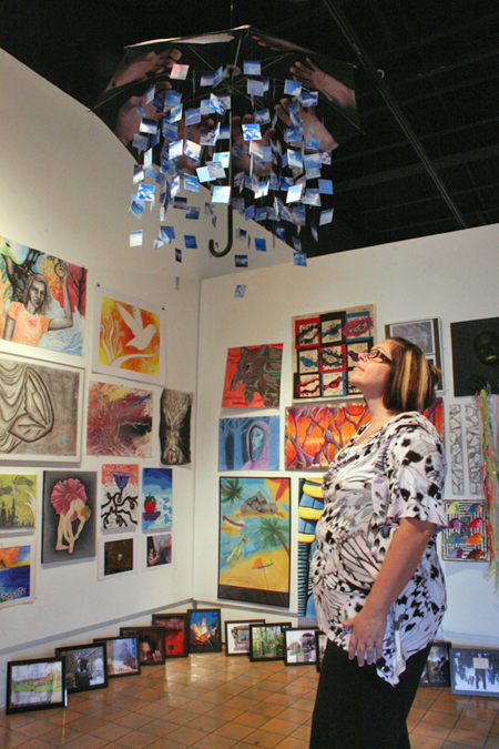 Person gazing at gallery full of art