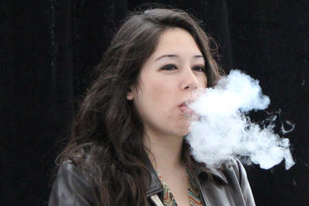 young woman breathing visible vapour