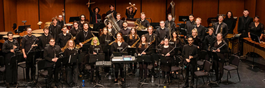 Large group shot of University Wind Ensemble on stage