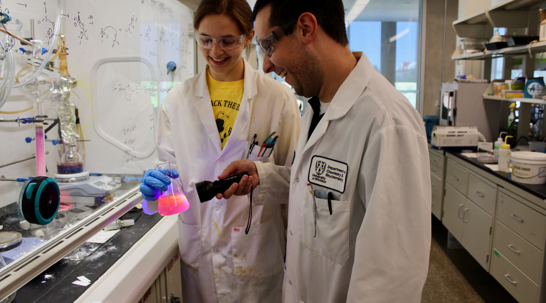 A student and faculty member performing an experiment in the lab