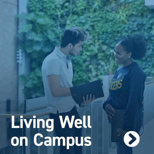 Female student conversing with male student at medical education building