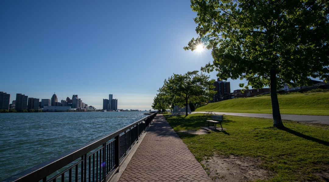 Detroit river view with railing and trees