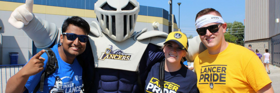 three s students posing with the UWindsor mascot Winston