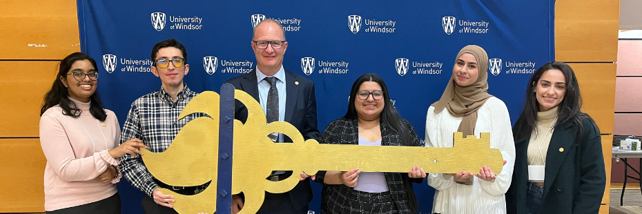 Students holding the Key for the Golden Key International Honour Society