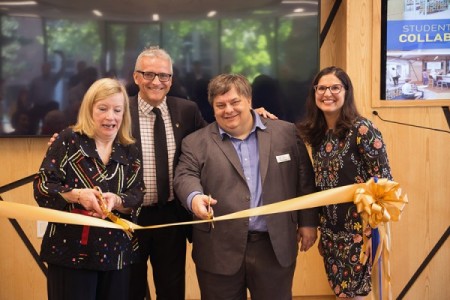 Donor Mary Hatch gets some help with ribbon cutting from UWindsor president Robert Gordon, head librarian Pascal Calarco, and associate Karen Pillon.