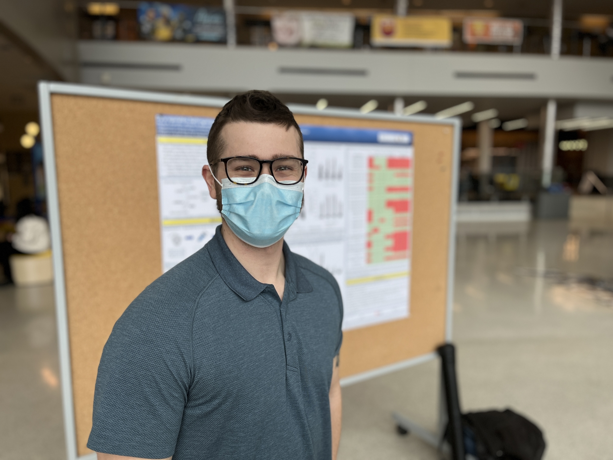 Student presenting research poster at UWill Discover