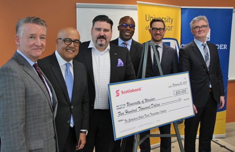 UWindsor interim president Douglas Kneale is shown with Cross-Border Institute director Bill Anderson, flank Scotiabank officials Alex Besharat, senior vice-president and head of Canadian wealth management; Terry Roman, director and market lead of commercial banking; Charles Achampong, director of academic partnership 