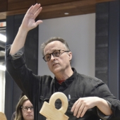 Sculpture instructor Rod Strickland discusses one of his student’s creations during the class’s critique evening.