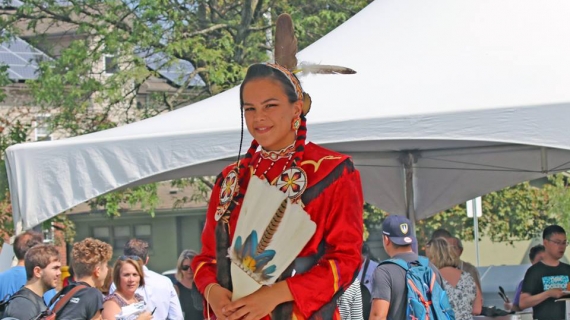 A girl in ceremonial dress is shown as part of the Turtle Island Walk day of celebration. 