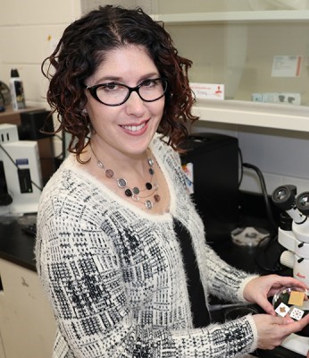 Dr. Tricia Carmichael in Lab with Microscope and Wearable Technology